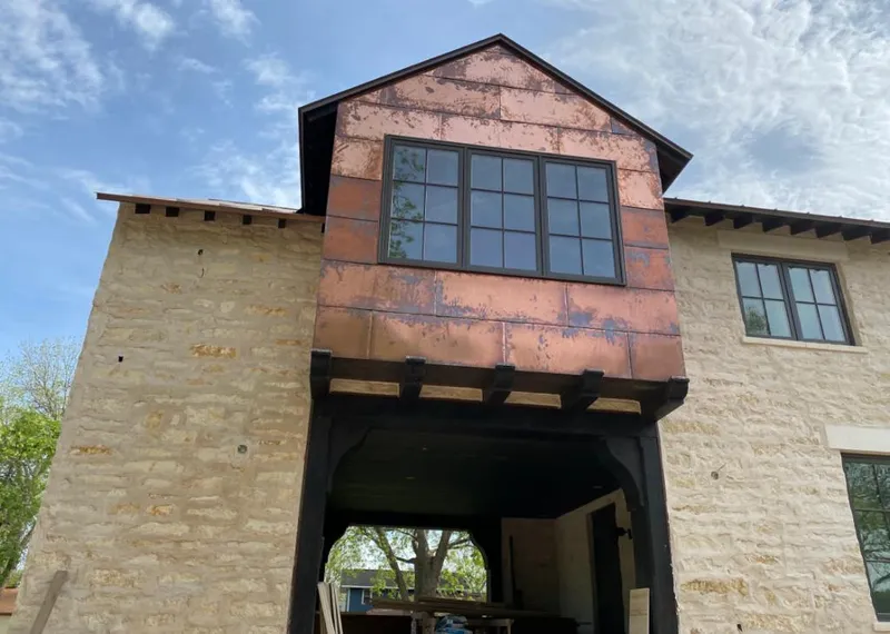 Copper metal panel facade on a stone building for Skylight Installation in Port Isabel